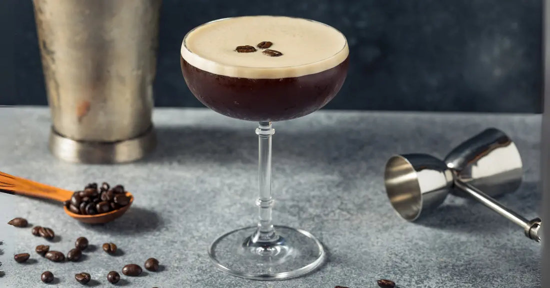 Espresso martini served in a coupe glass with a velvety crema, accompanied by coffee beans and bartending tools