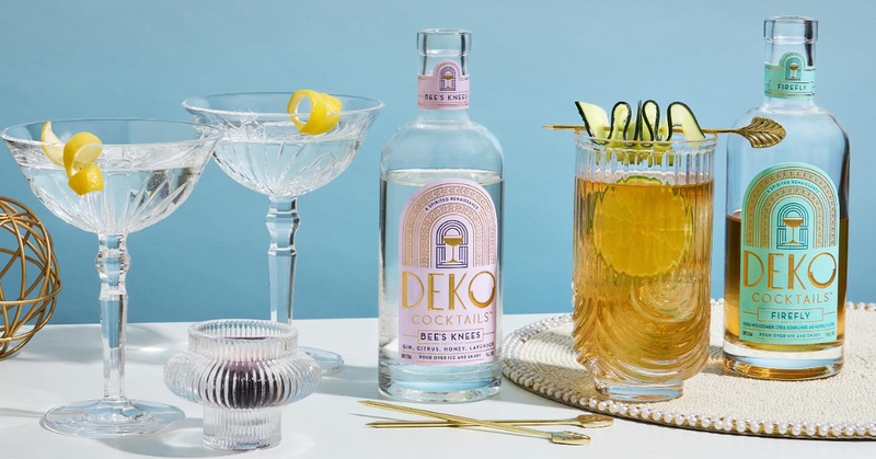 Premixed cocktails from Deko displayed with elegant glassware and citrus garnishes on a stylish surface.