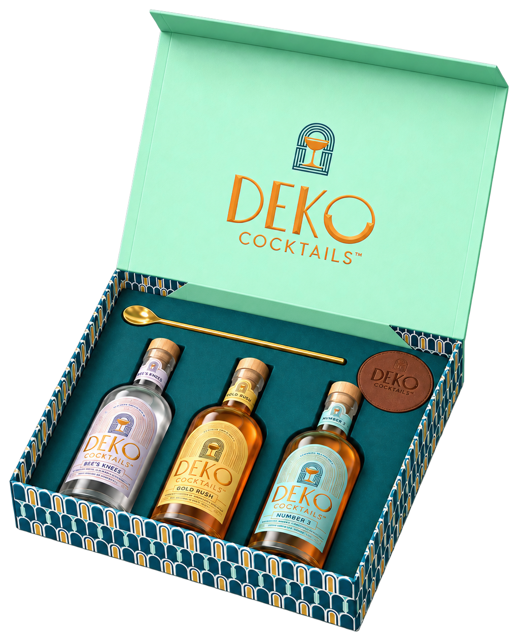 The Cocktail Gift Box by Deko Cocktails, open, with three bottled cocktails, a gold bar spoon and leather coasters